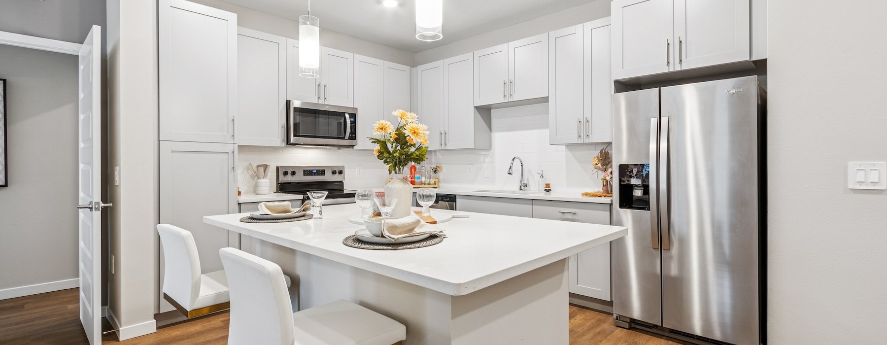 a kitchen with white cabinets
